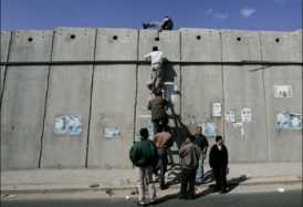   شبان فلسطينيون غاضبون يحفرون «فتحة» بالجدار العازل بالعيزرية
