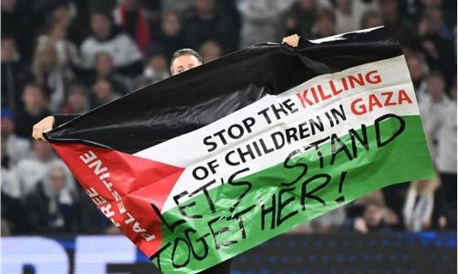 "أوقفوا قتل الأطفال في غزة ".. مشجع يجوب بعلم فلسطين أثناء مباراة مانشستر يونايتد وكوبنهاجن 