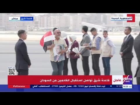 مواطن عائد من السودان يرفع صورة الرئيس السيسي وعلم مصر