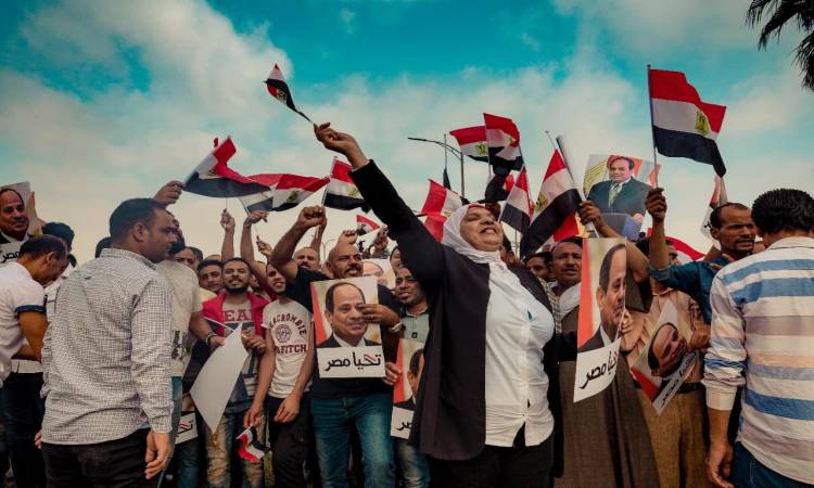  بالأعلام واللافتات .. المصريون يحتشدون لاستقبال الرئيس عقب عودته للقاهرة (فيديو)